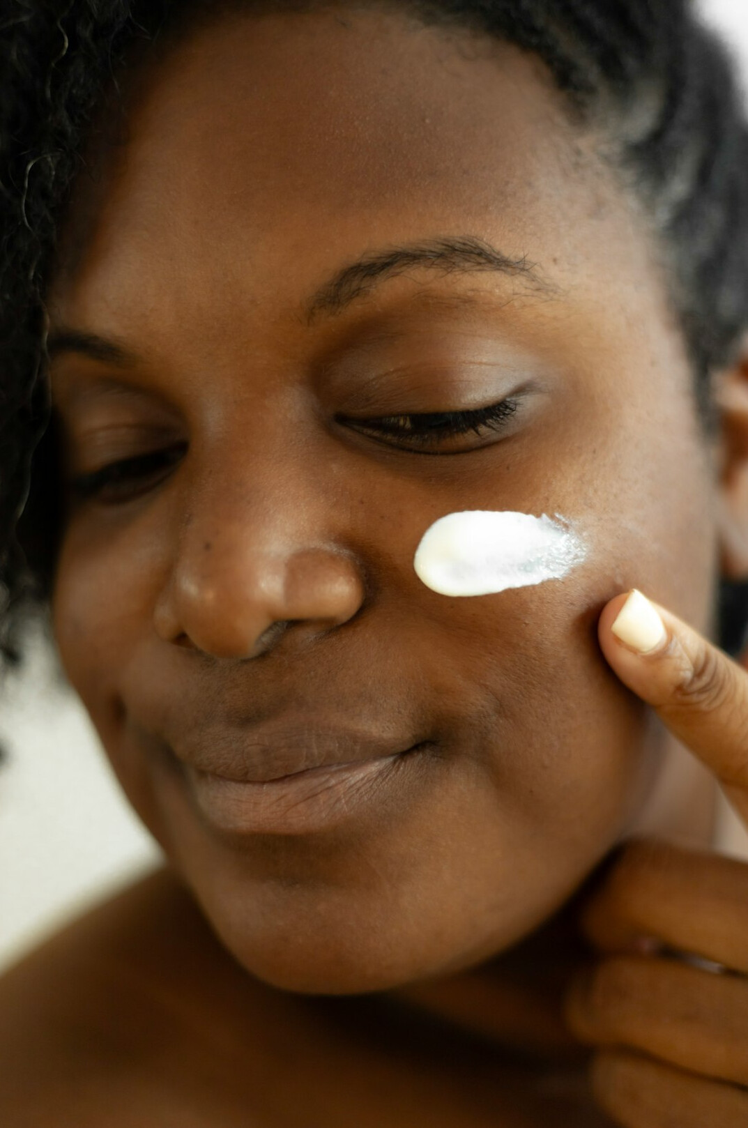 woman using skincare products